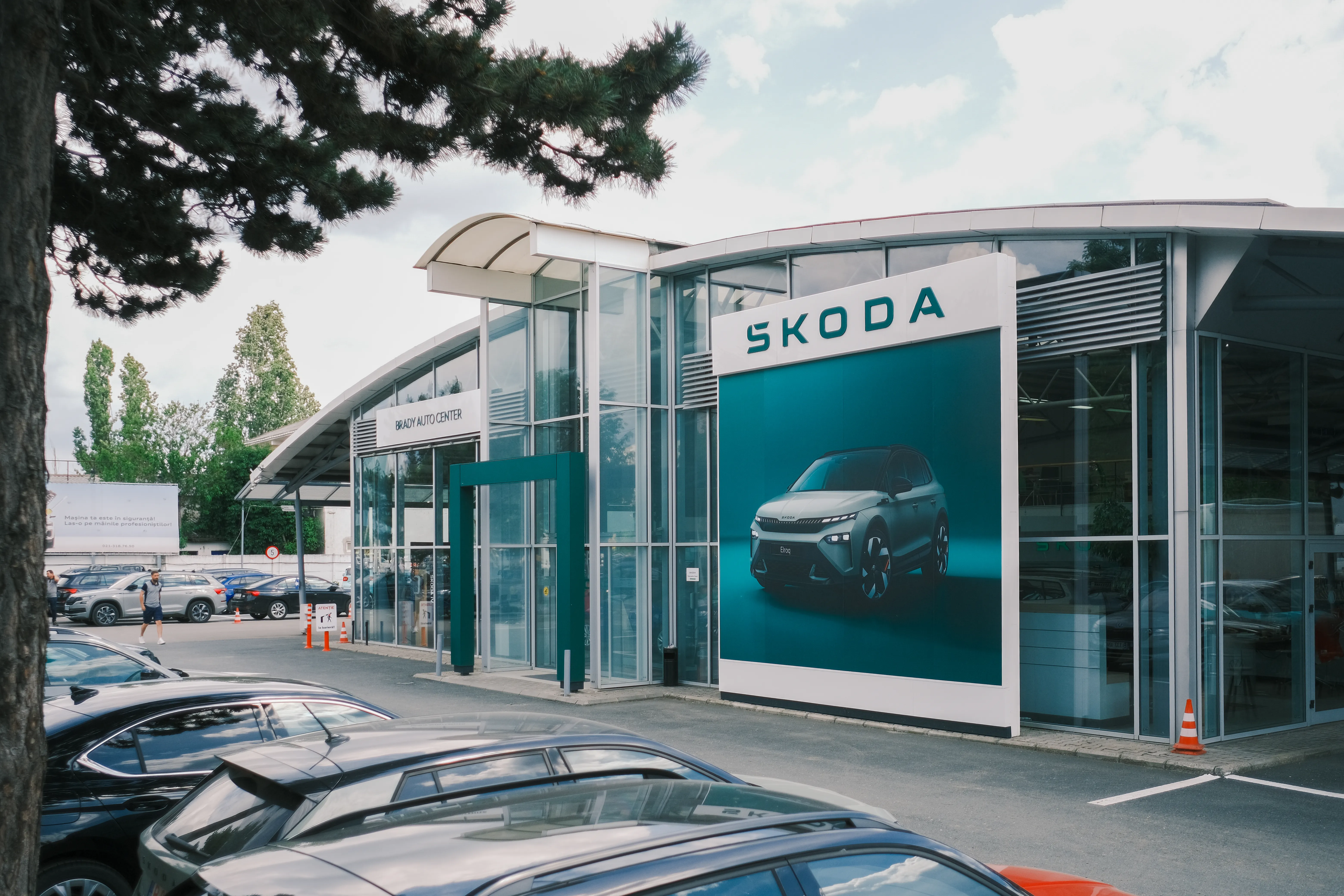 Brady Auto Center Skoda dealership exterior, wide angle with parked cars in the foreground