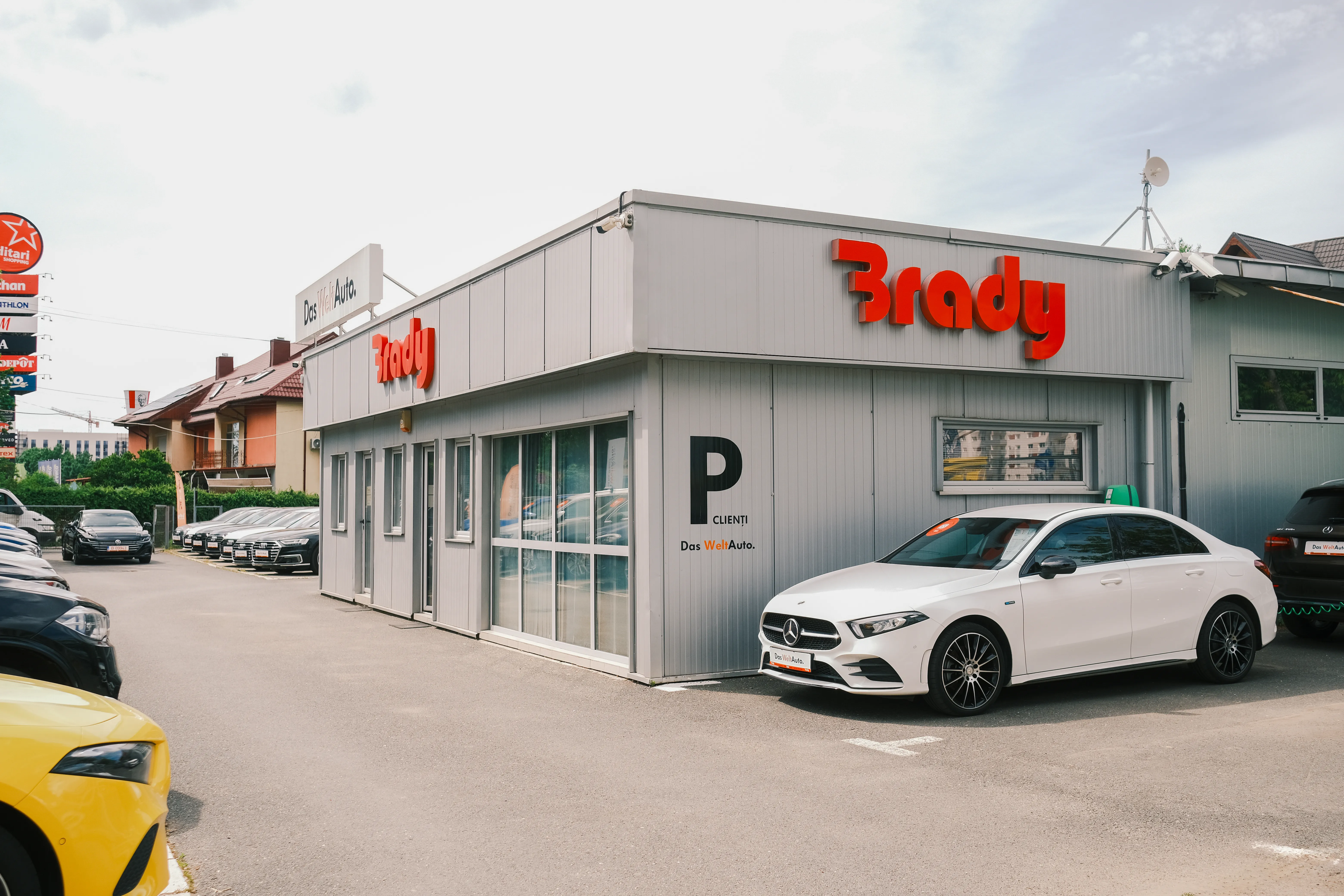 Brady Auto Center's own branded service building, red signage, a white car parked out front