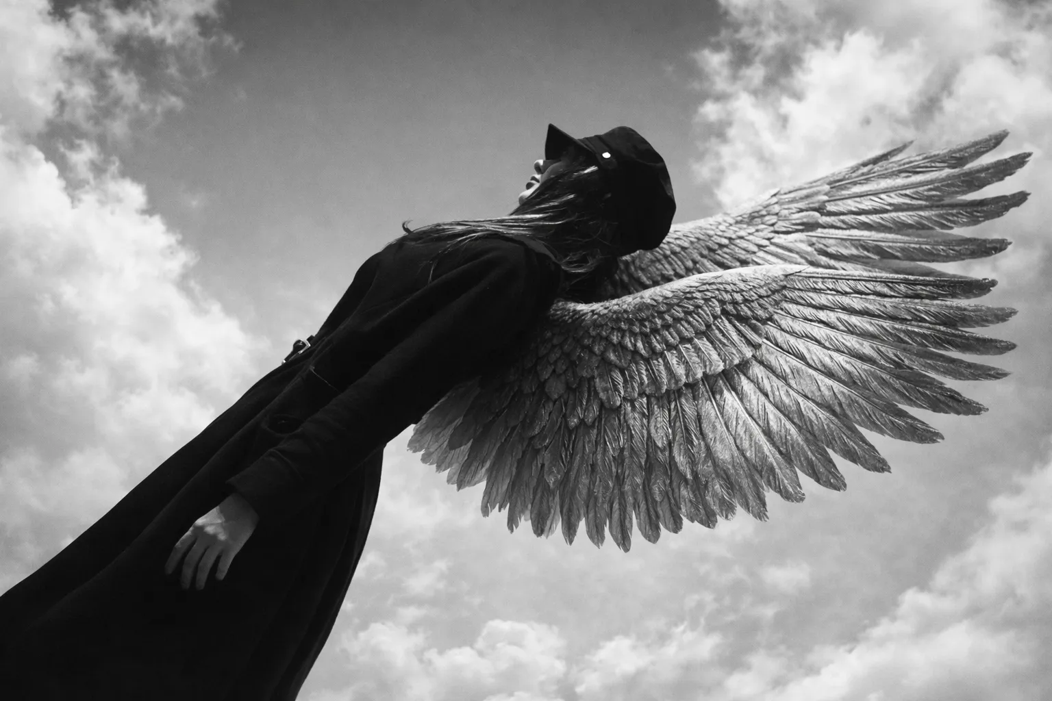 Surreal silhouette of a winged figure against clouds