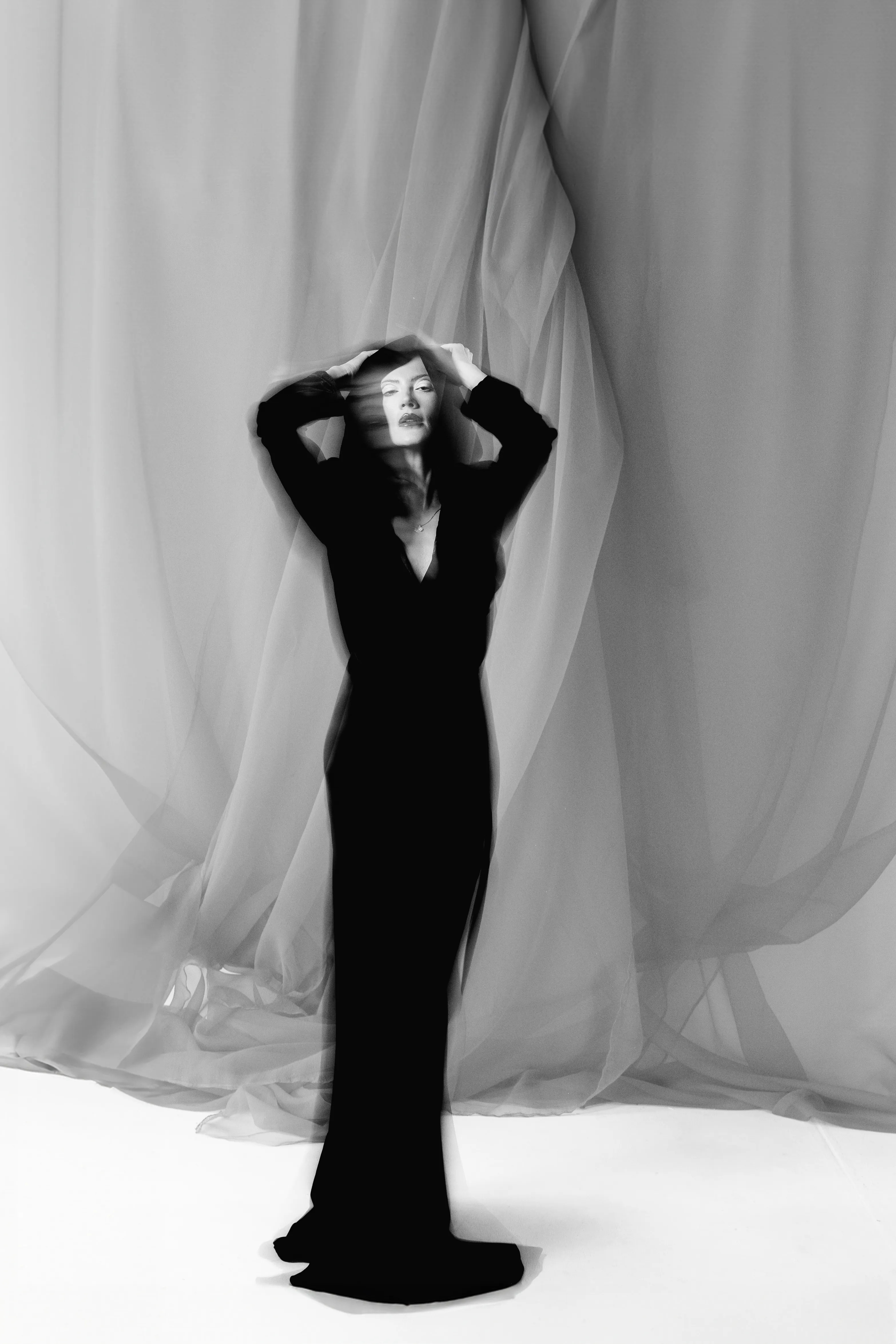 The same figure and gown, caught mid-motion